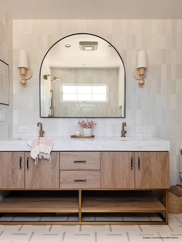 White oak double vanity with arched mirror and glossy zellige tile wall